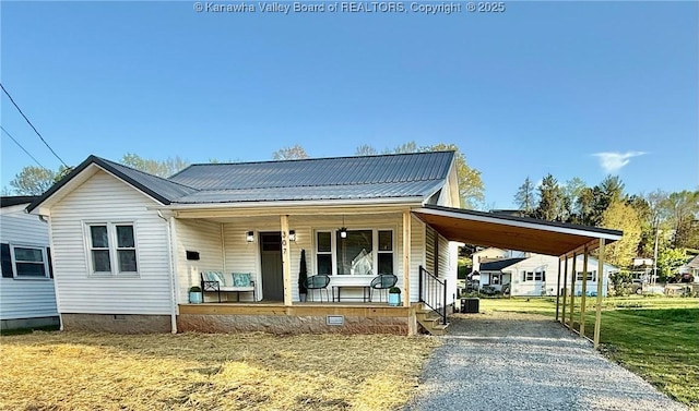 view of front of house featuring a porch, driveway, crawl space, and metal roof