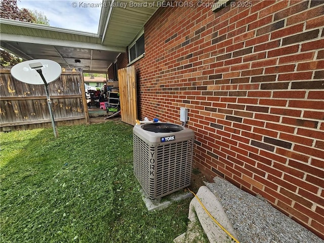 exterior details featuring central AC and fence