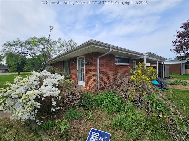 view of side of property with brick siding