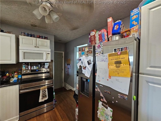 kitchen with baseboards, stainless steel appliances, dark wood-style flooring, white cabinetry, and a ceiling fan