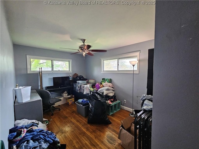 home office with wood finished floors and a ceiling fan