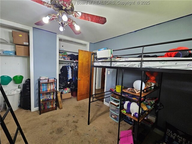 bedroom featuring two closets and carpet flooring