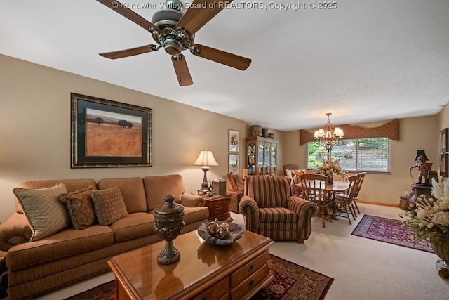 carpeted living room featuring ceiling fan with notable chandelier