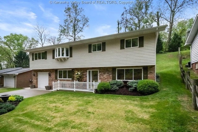 view of front of property featuring concrete driveway, a front yard, a garage, and brick siding
