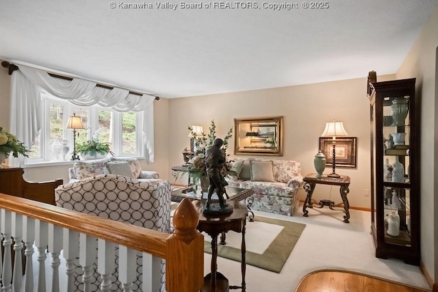 living room featuring carpet flooring and baseboards