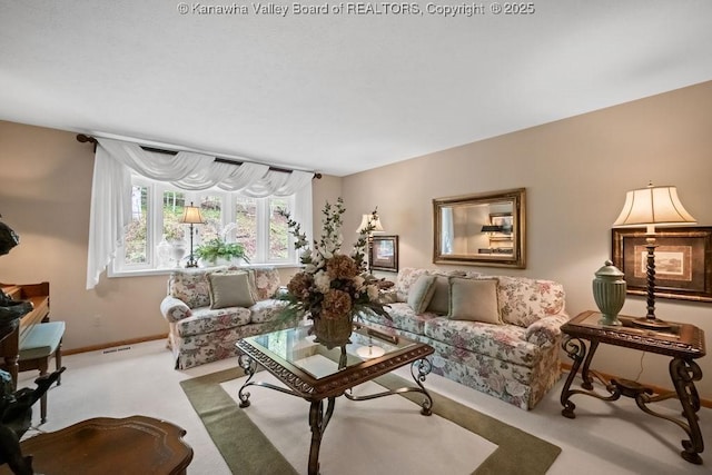 living area featuring visible vents, carpet, and baseboards