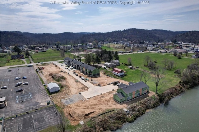 bird's eye view featuring a water view and a forest view