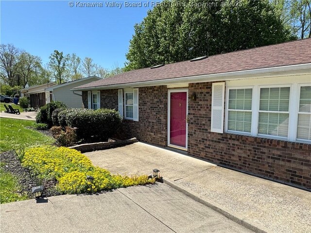 168 Jane Dr, Culloden, WV 25510 - ranch-style house featuring a patio, brick siding, and a shingled roof