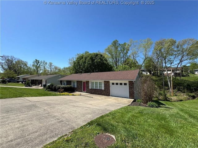 168 Jane Dr, Culloden, WV 25510 - ranch-style house with concrete driveway, a front yard, brick siding, and a garage