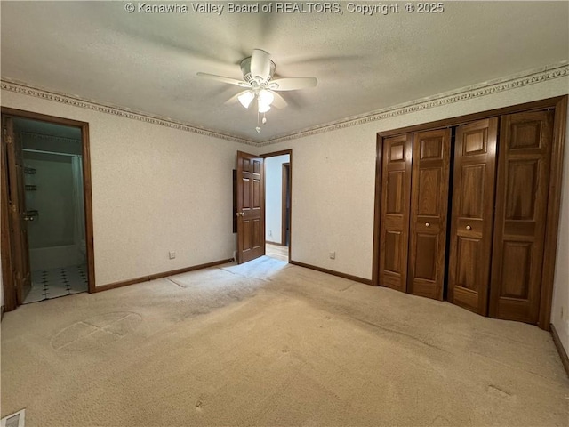 168 Jane Dr, Culloden, WV 25510 - unfurnished bedroom with a closet, a textured ceiling, light colored carpet, and baseboards