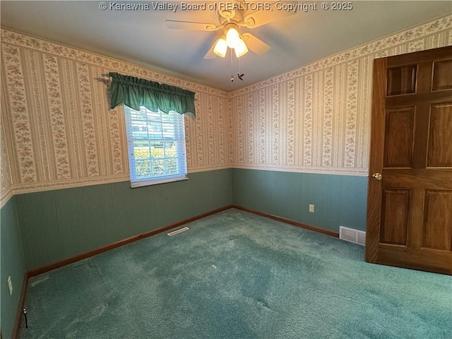 168 Jane Dr, Culloden, WV 25510 - carpeted empty room with visible vents, wainscoting, and ceiling fan