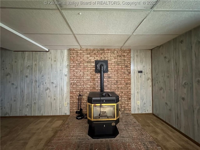 168 Jane Dr, Culloden, WV 25510 - details featuring wood walls, a paneled ceiling, a wood stove, and baseboards