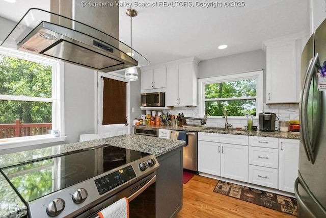 901 Evanwood Rd, Charleston, WV 25314 - kitchen featuring appliances with stainless steel finishes, ventilation hood, a sink, white cabinetry, and decorative backsplash