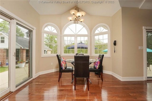 219 Deerhaven Ln, Cross Lanes, WV 25313 - dining area with an inviting chandelier, vaulted ceiling, wood finished floors, and baseboards