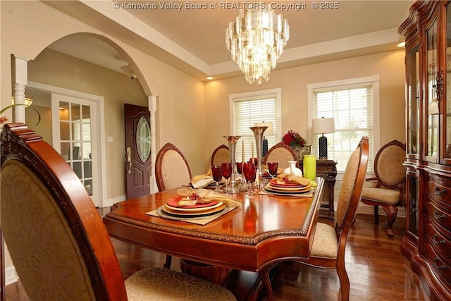 219 Deerhaven Ln, Cross Lanes, WV 25313 - dining area with arched walkways, a notable chandelier, baseboards, and dark wood finished floors