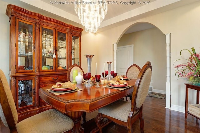 219 Deerhaven Ln, Cross Lanes, WV 25313 - dining space with baseboards, a notable chandelier, dark wood finished floors, and arched walkways
