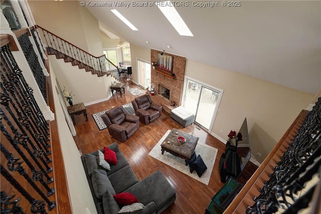 219 Deerhaven Ln, Cross Lanes, WV 25313 - living room with wood finished floors, baseboards, high vaulted ceiling, and stairs