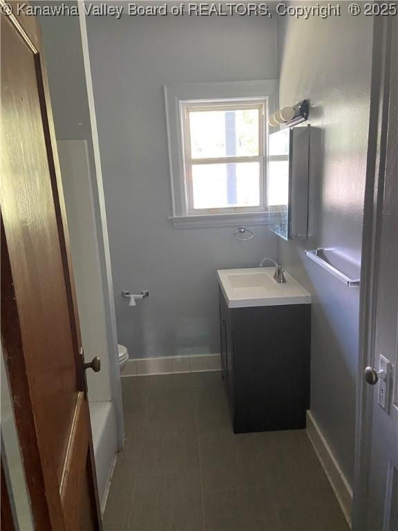 bathroom with vanity, tile patterned floors, and toilet