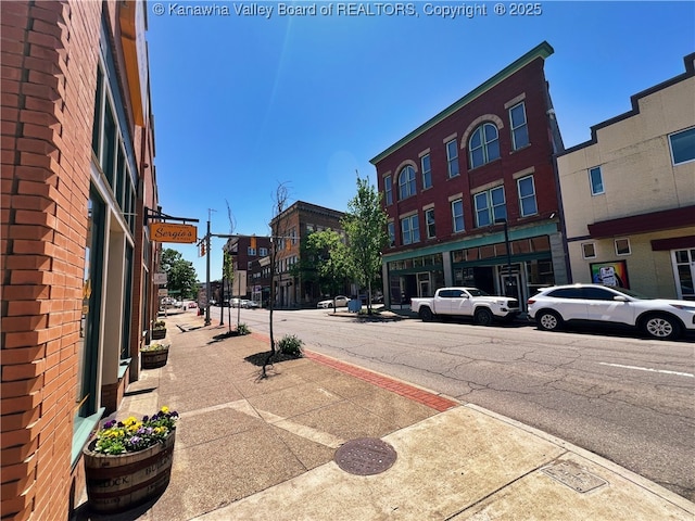 view of street with sidewalks, street lighting, and curbs