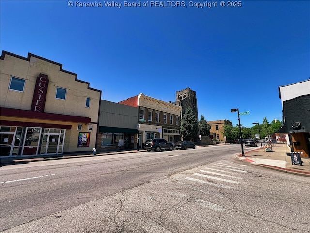 view of road with street lighting, curbs, and sidewalks