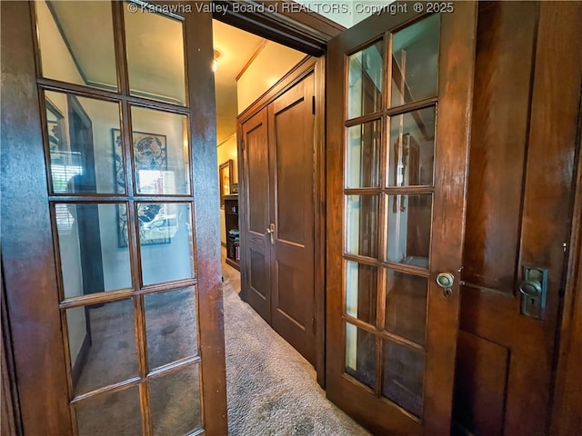 corridor with carpet flooring and french doors