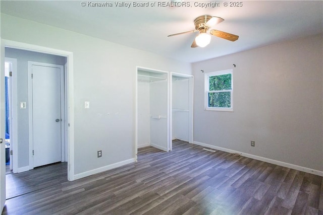 unfurnished bedroom with dark wood-style flooring, baseboards, a ceiling fan, and a closet
