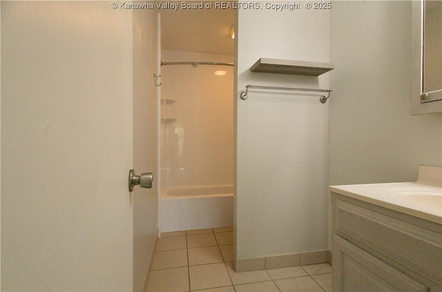 full bath with vanity, baseboards, shower / tub combination, and tile patterned flooring