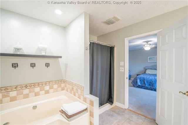 full bath featuring tile patterned floors, a bath, a stall shower, and a ceiling fan