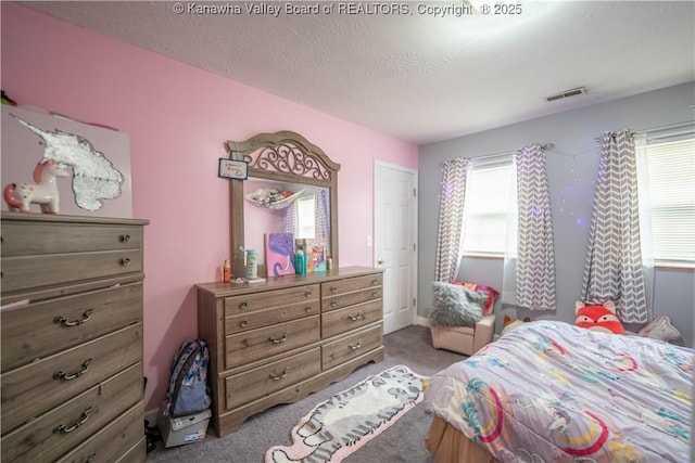 bedroom with carpet flooring and a textured ceiling