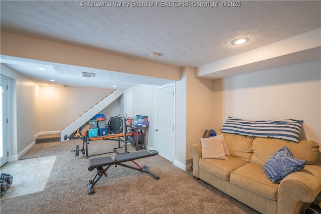 workout area featuring a textured ceiling, carpet, baseboards, and recessed lighting