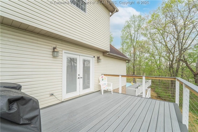 wooden deck with french doors and area for grilling