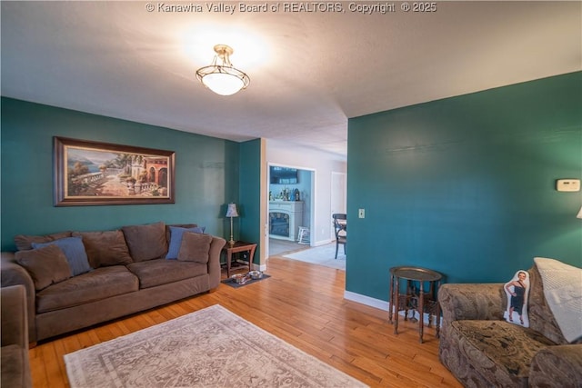 living room featuring hardwood / wood-style floors and baseboards