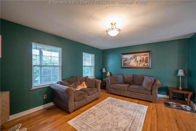 living area with wood finished floors and baseboards