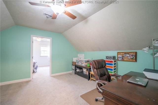 office with a ceiling fan, lofted ceiling, baseboards, carpet floors, and a textured ceiling