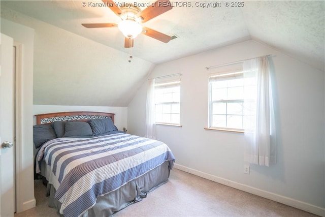bedroom with vaulted ceiling, baseboards, carpet, and a ceiling fan