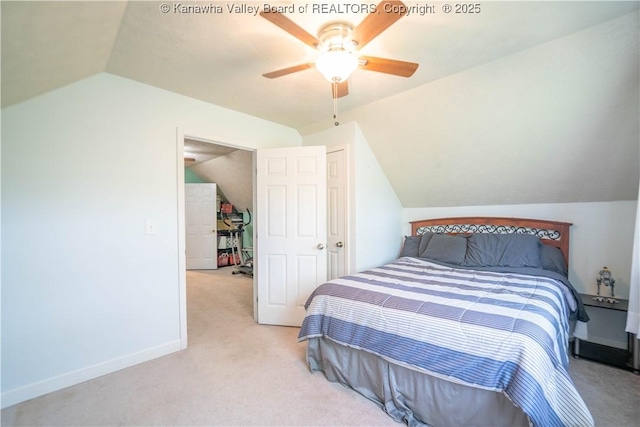 carpeted bedroom featuring vaulted ceiling, baseboards, and a ceiling fan