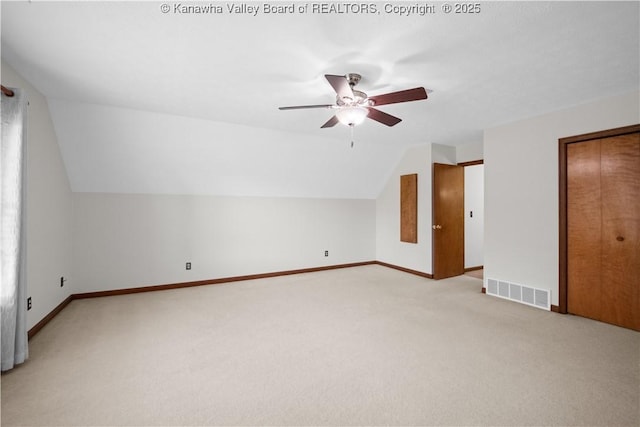 bonus room featuring visible vents, a ceiling fan, baseboards, and light carpet