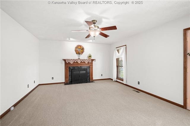 unfurnished living room featuring ceiling fan, light carpet, baseboards, a high end fireplace, and visible vents