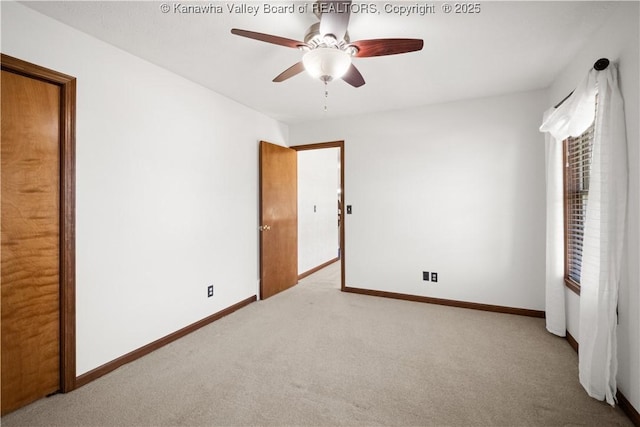 unfurnished bedroom featuring carpet flooring, a ceiling fan, and baseboards
