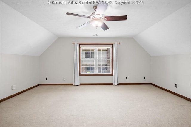 bonus room with baseboards, a ceiling fan, lofted ceiling, and light carpet