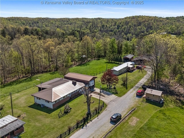 drone / aerial view with a wooded view