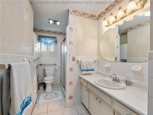 full bathroom featuring tile patterned flooring, vanity, toilet, tile walls, and a shower stall