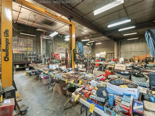 misc room with concrete flooring and a workshop area