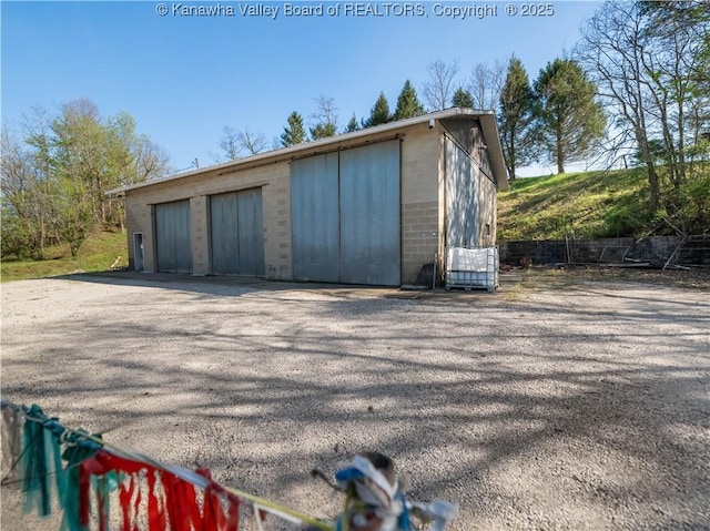 detached garage featuring fence