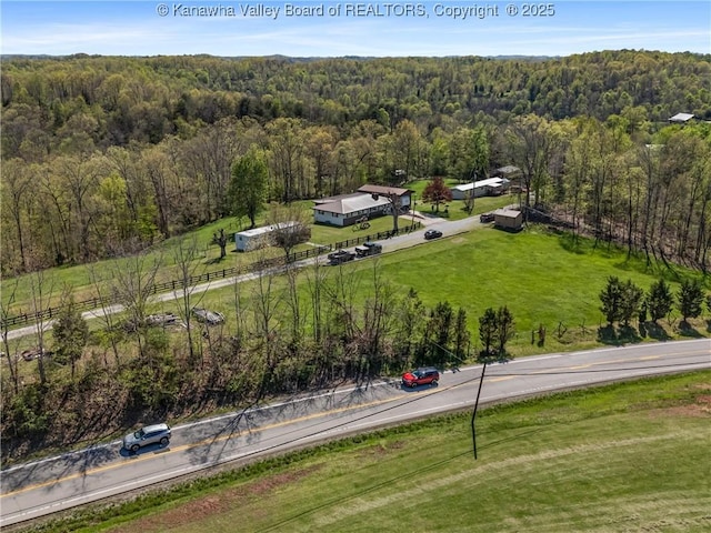 birds eye view of property with a forest view