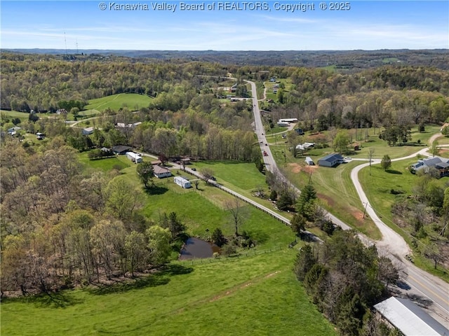drone / aerial view featuring a forest view