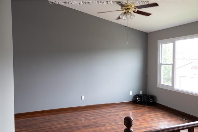 unfurnished room with baseboards, ceiling fan, wood finished floors, and lofted ceiling