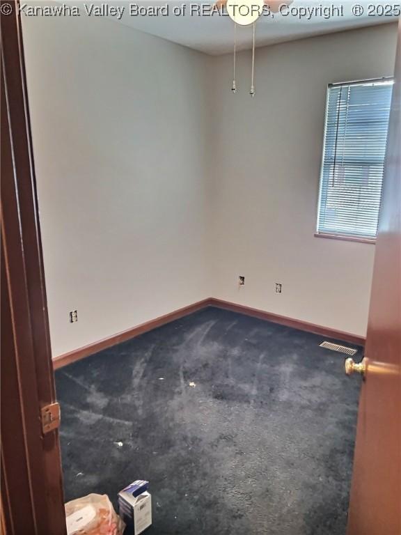unfurnished room featuring carpet floors, baseboards, and visible vents