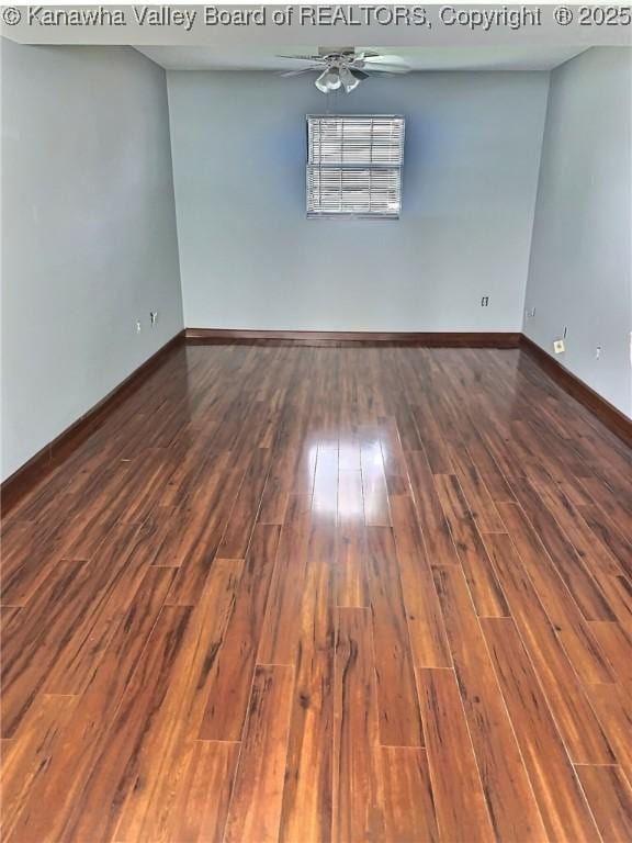 spare room with baseboards, ceiling fan, and hardwood / wood-style flooring