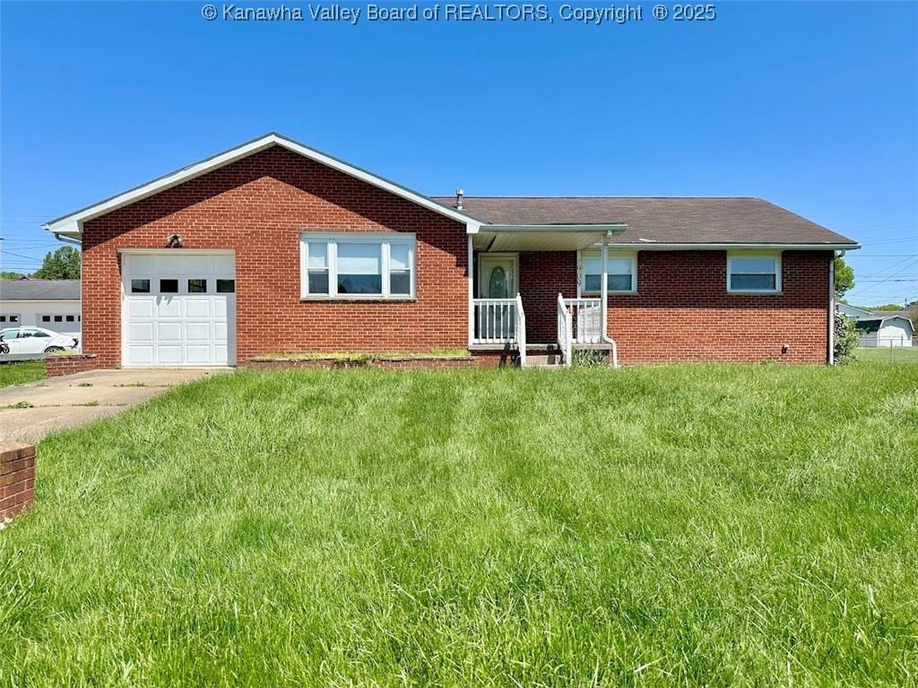 909 Virginia St, Ravenswood, WV 26164 - ranch-style house with a garage, driveway, brick siding, and a front yard